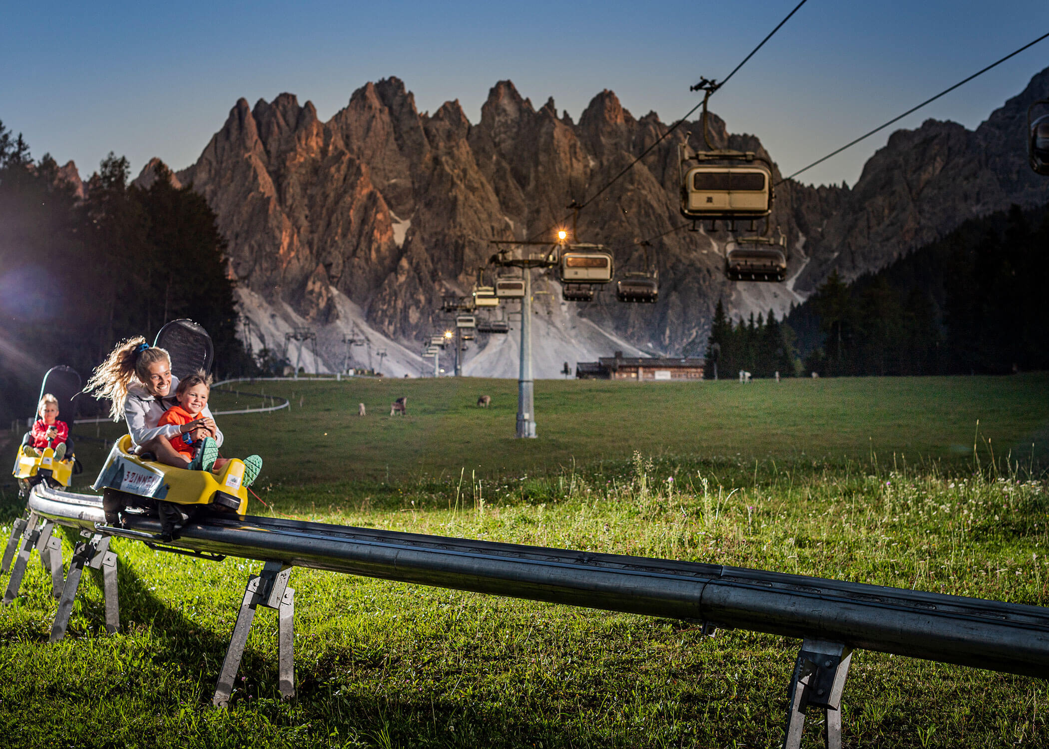 A family riding a fun bob on Haunold