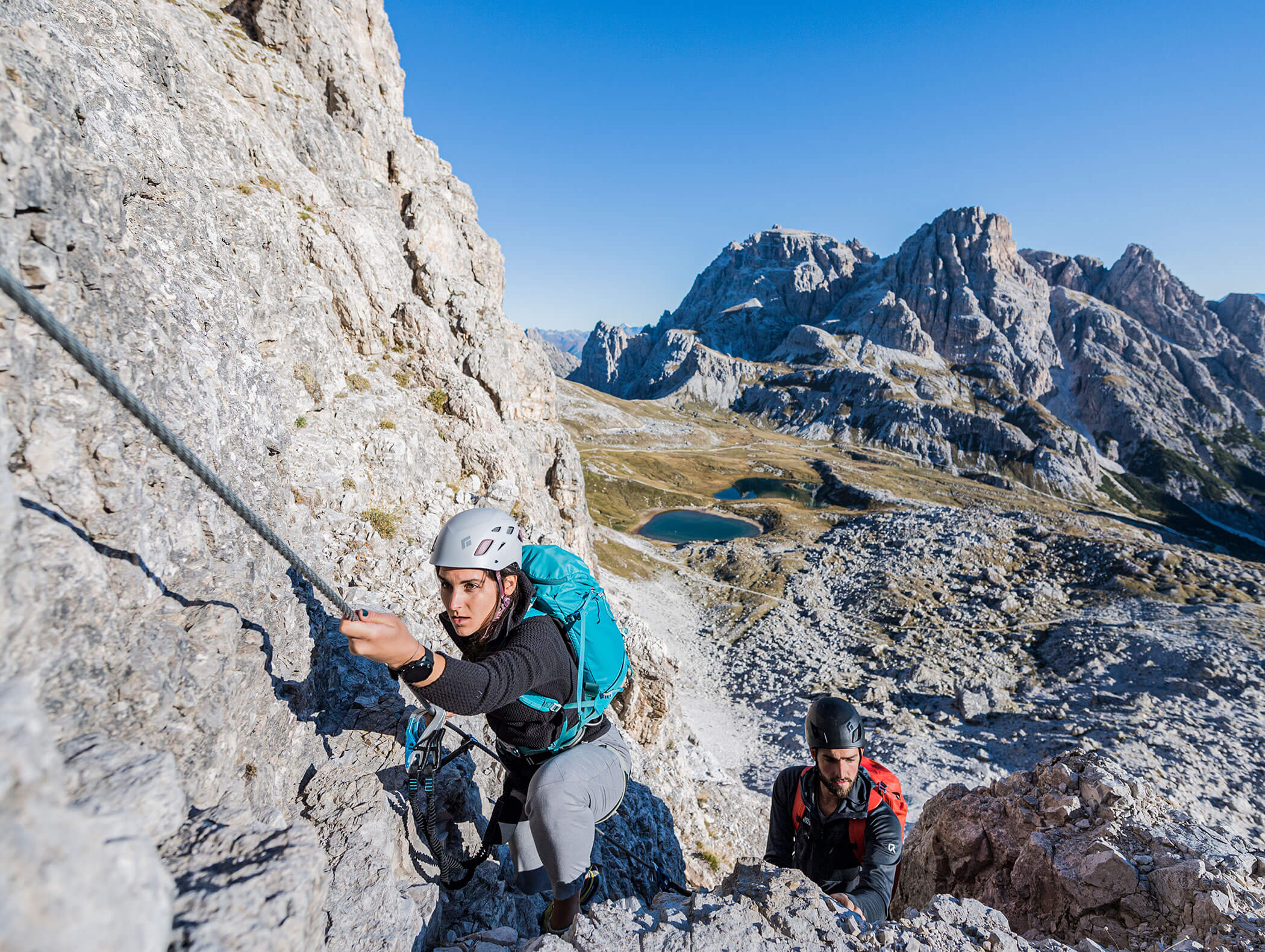 A couple on a via ferrata in the Dolomites