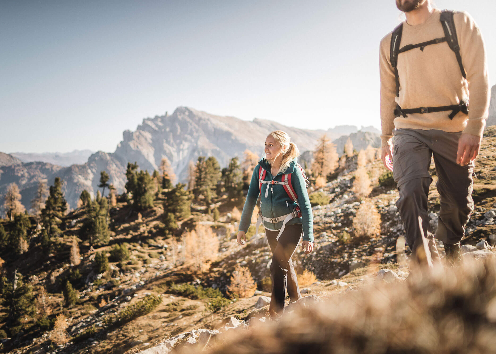 Two hikers on the trail in autumn