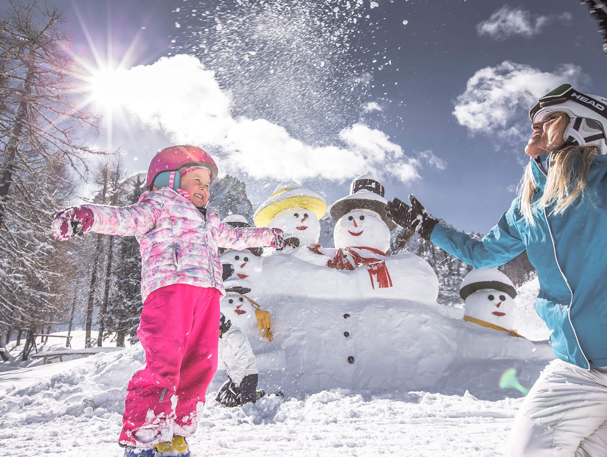 Mother and daughter playing in the snow